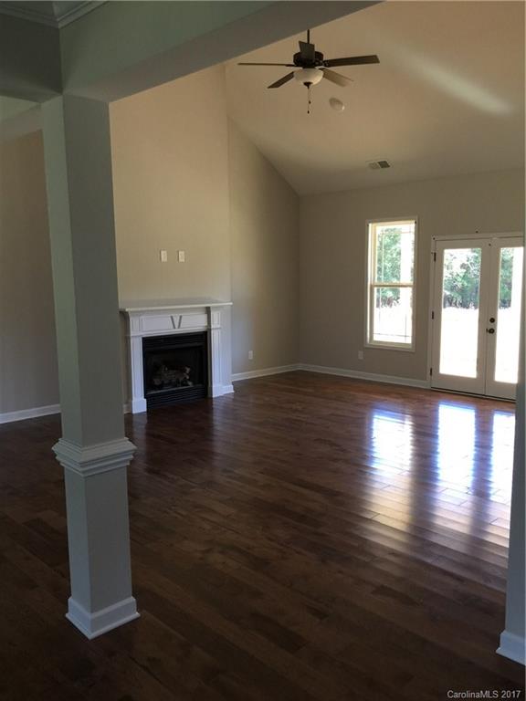 1854 State Rd S-46-168, Unit 4 York, SC 29745 - Photo 10 of 20 a view of empty room with wooden floor and fireplace
