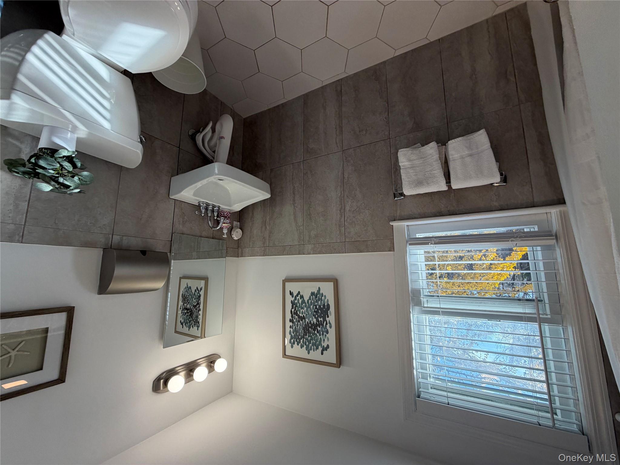 380 Eds Road Southold, NY 11971 - Photo 12 of 19 Bathroom featuring a wainscoted wall, tile walls, and tile patterned flooring