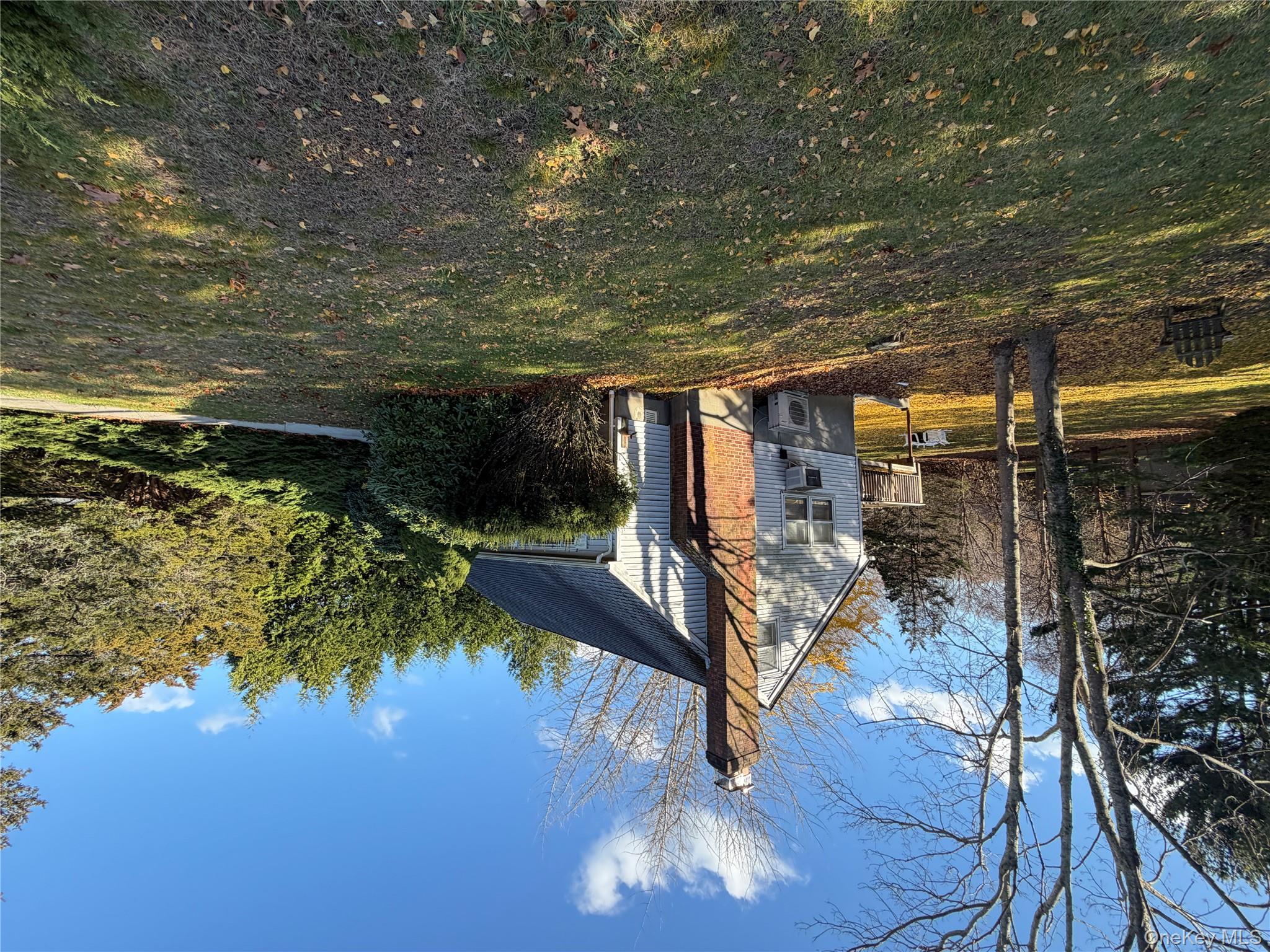 380 Eds Road Southold, NY 11971 - Photo 15 of 19 View of property exterior featuring a chimney and a lawn