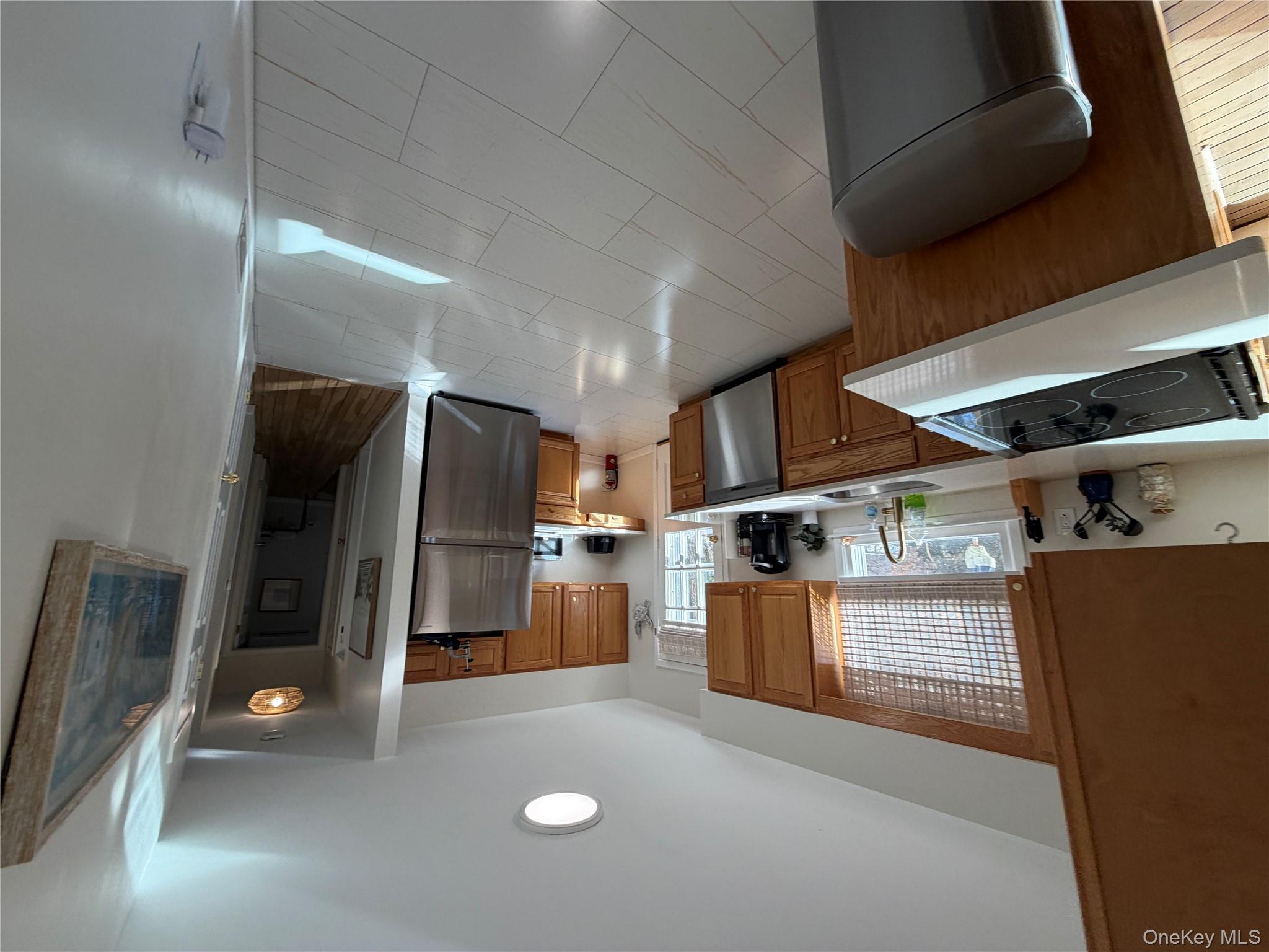 380 Eds Road Southold, NY 11971 - Photo 5 of 19 Kitchen featuring light countertops, stainless steel appliances, and brown cabinets