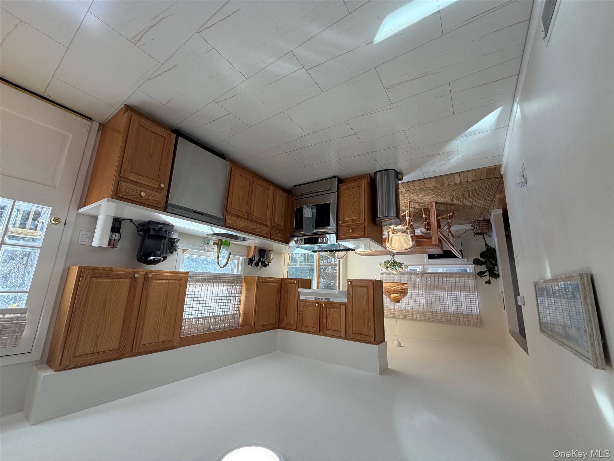 380 Eds Road Southold, NY 11971 - Photo 6 of 19 Kitchen with brown cabinets, stainless steel stove, dishwasher, and exhaust hood