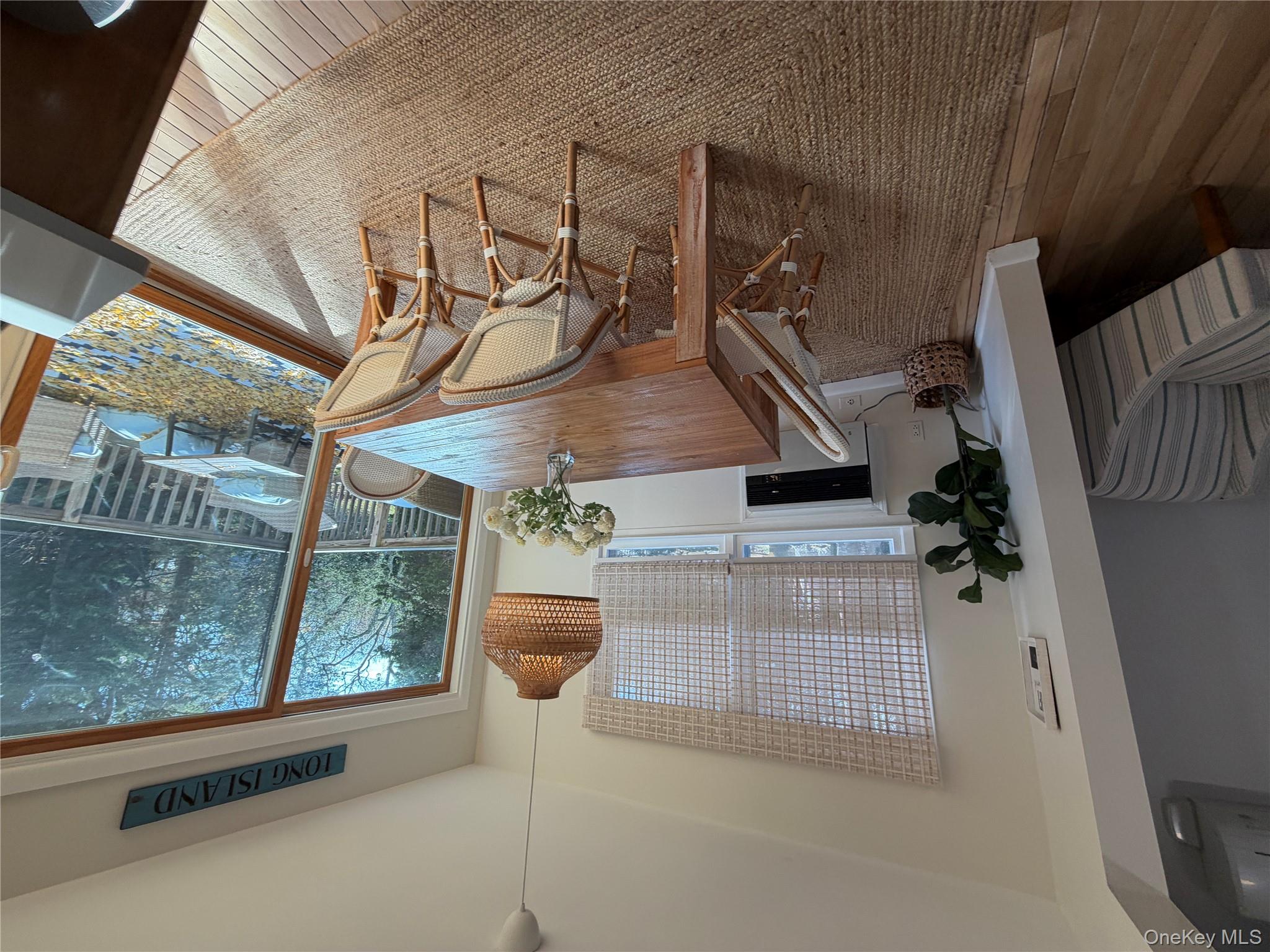 380 Eds Road Southold, NY 11971 - Photo 7 of 19 Dining room with a wall unit AC, wood-type flooring, and heating unit