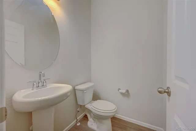 a bathroom with a sink toilet and a mirror