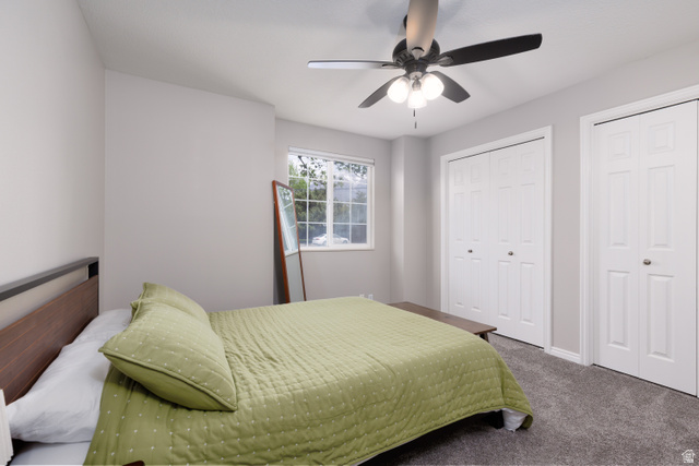 260 400 North, Unit 1 Orem, UT 84057 - Photo 9 of 17 Bedroom featuring two closets, carpet, and ceiling fan