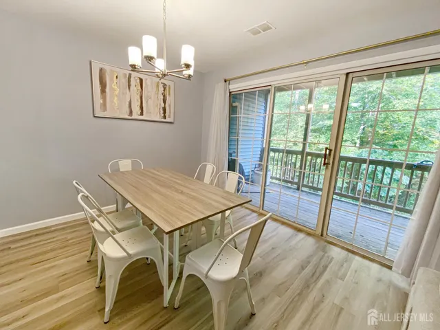 a view of a dining room with furniture wooden floor and a chandelier