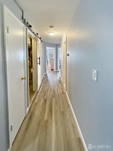 a view of hallway with wooden floor