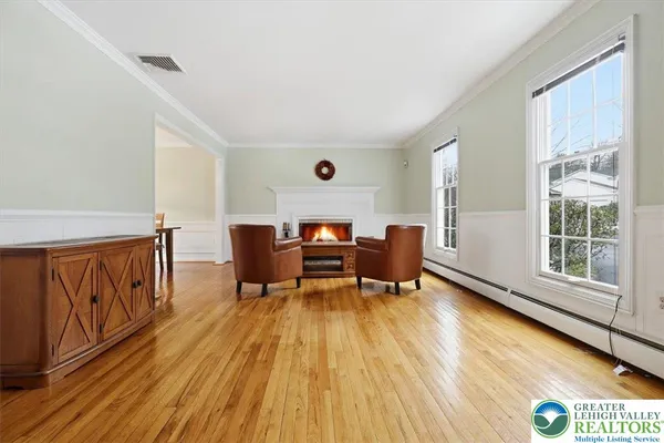 a view of entryway and hall with wooden floor
