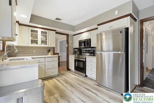 a kitchen that has a sink and a stove in it