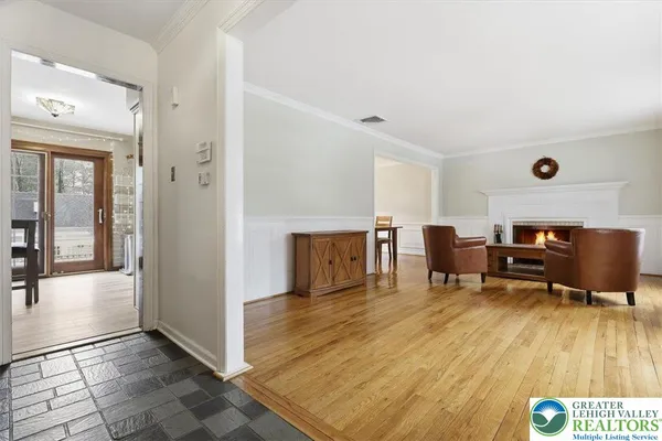 a room with table chairs and wooden floor