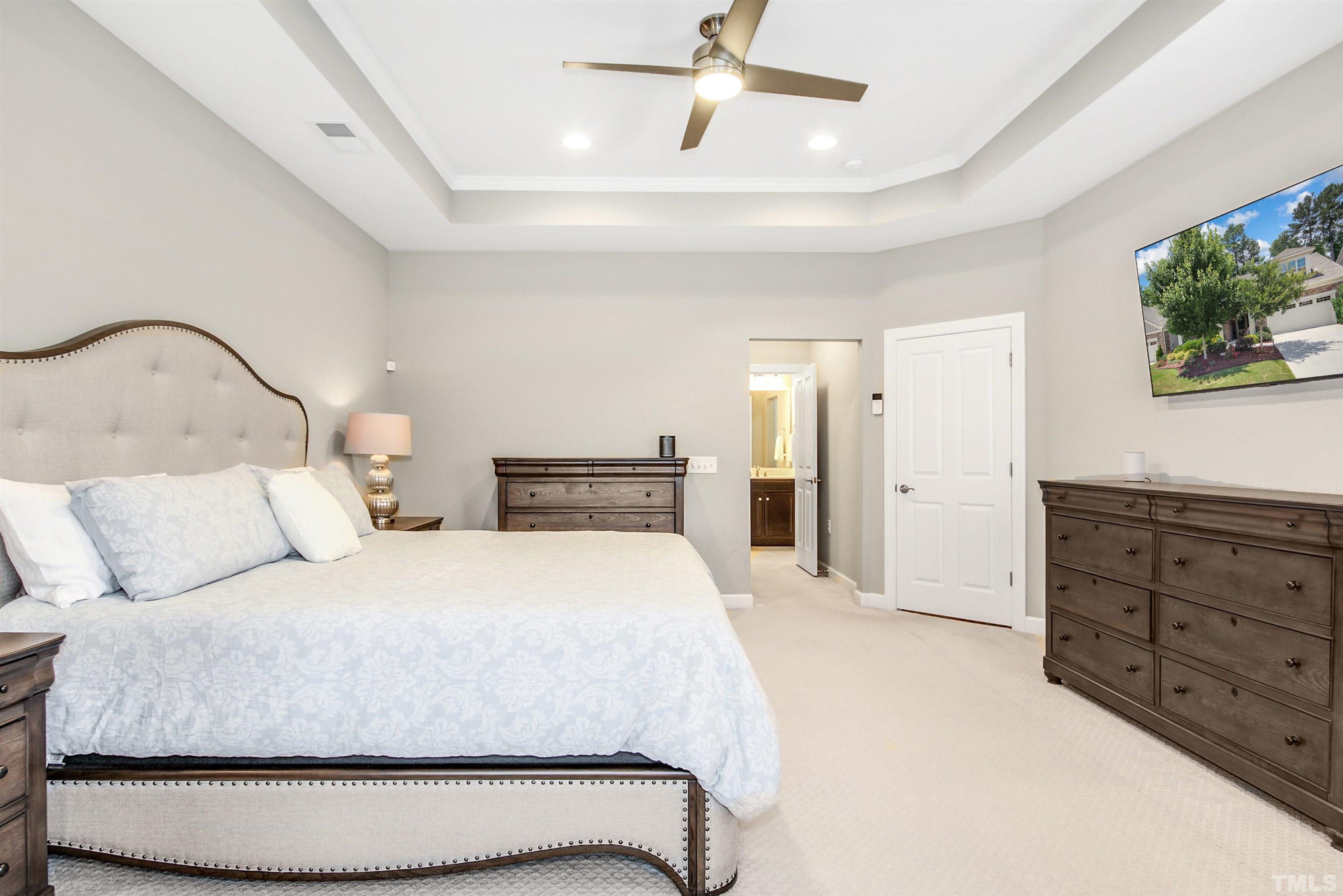 1313 Provision Place Wake Forest, NC 27587 - Photo 22 of 39 a bedroom with a bed and a flat screen tv