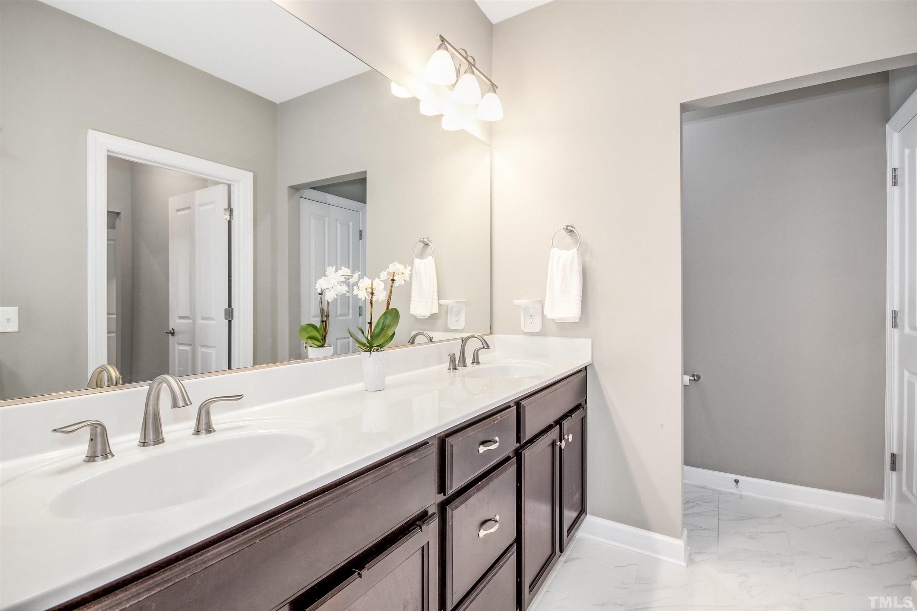 1313 Provision Place Wake Forest, NC 27587 - Photo 27 of 39 a bathroom with a double vanity sink and a mirror