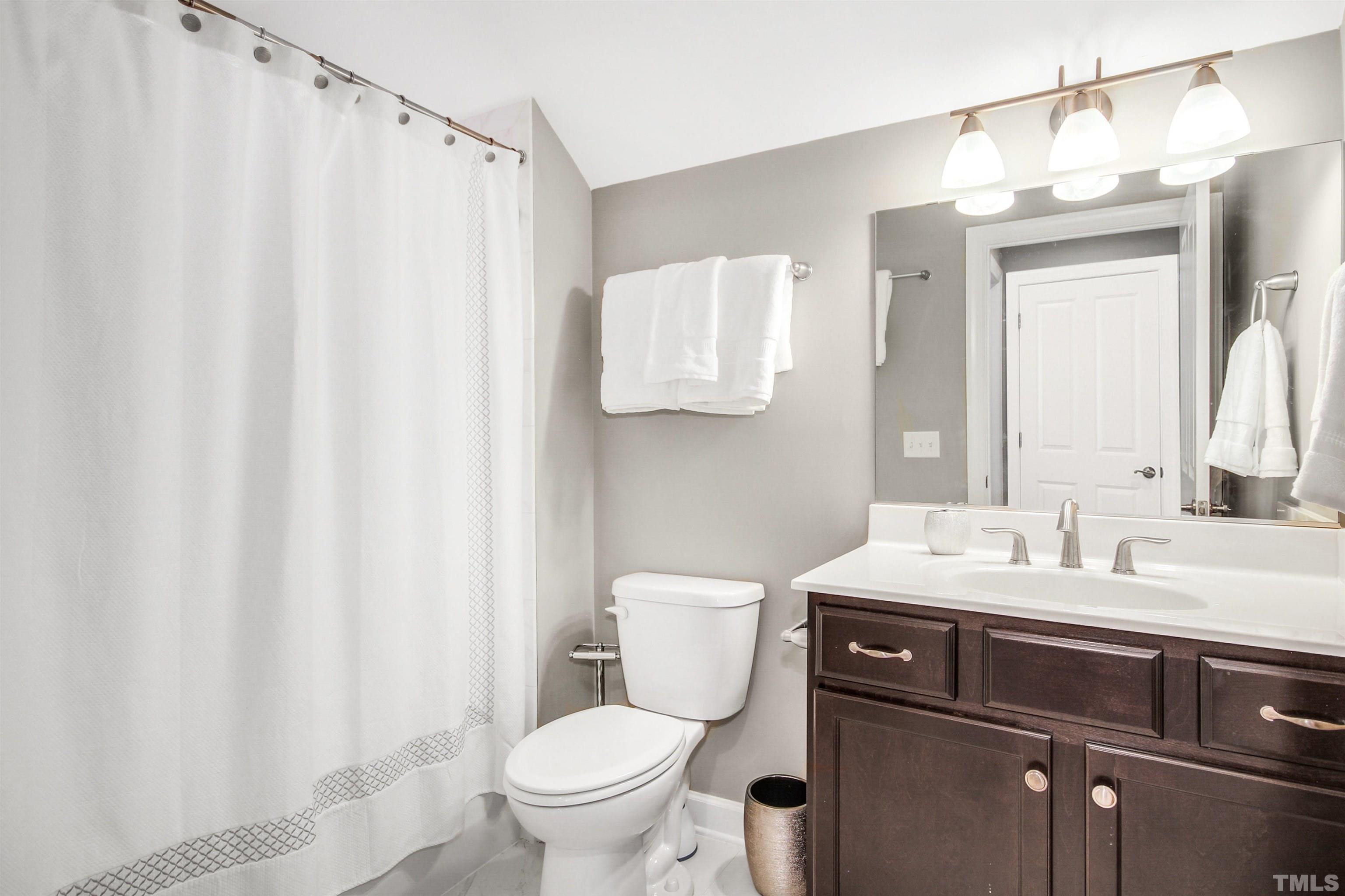 1313 Provision Place Wake Forest, NC 27587 - Photo 32 of 39 a bathroom with a sink a toilet and a mirror
