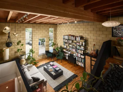 a bed sitting in a bathroom next to a shower curtain