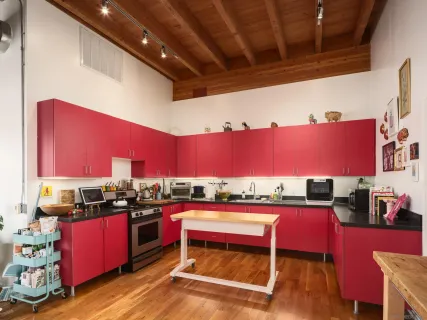 a bedroom with a bed and a flat tv screen next to a window