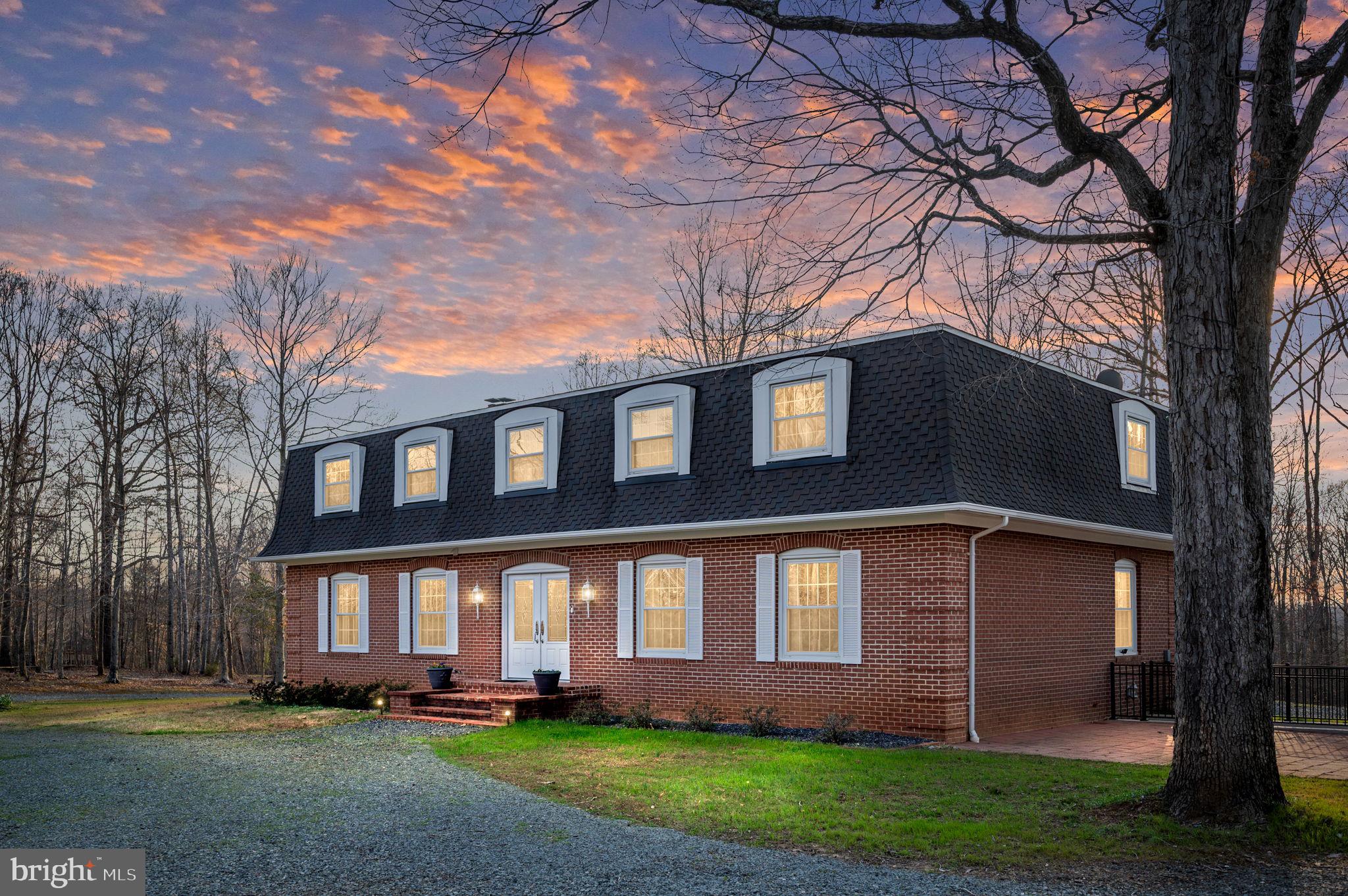 31 River Ridge Lane Fredericksburg, VA 22406 - Photo 1 of 70 a front view of a house with a garden and trees