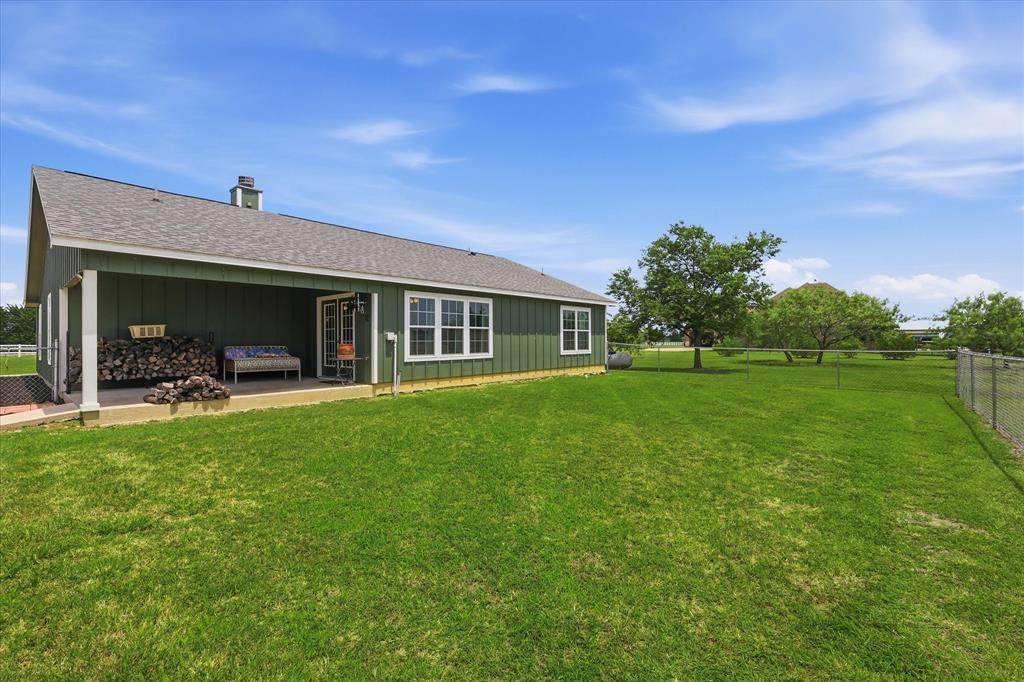 110 Highview Road Ennis, TX 75119 - Photo 35 of 40 Expansive green lawn surrounds a single-story structure with a covered patio