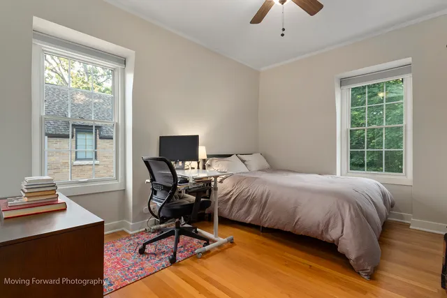a bedroom with a bed and a desk