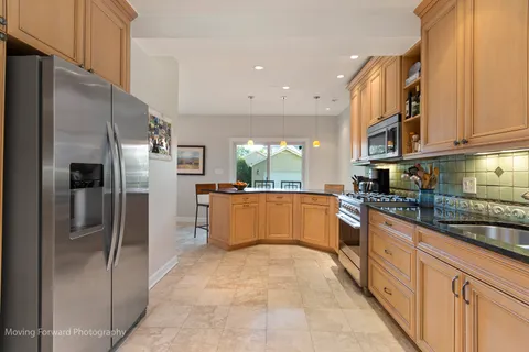 a large kitchen with stainless steel appliances lots of counter top space