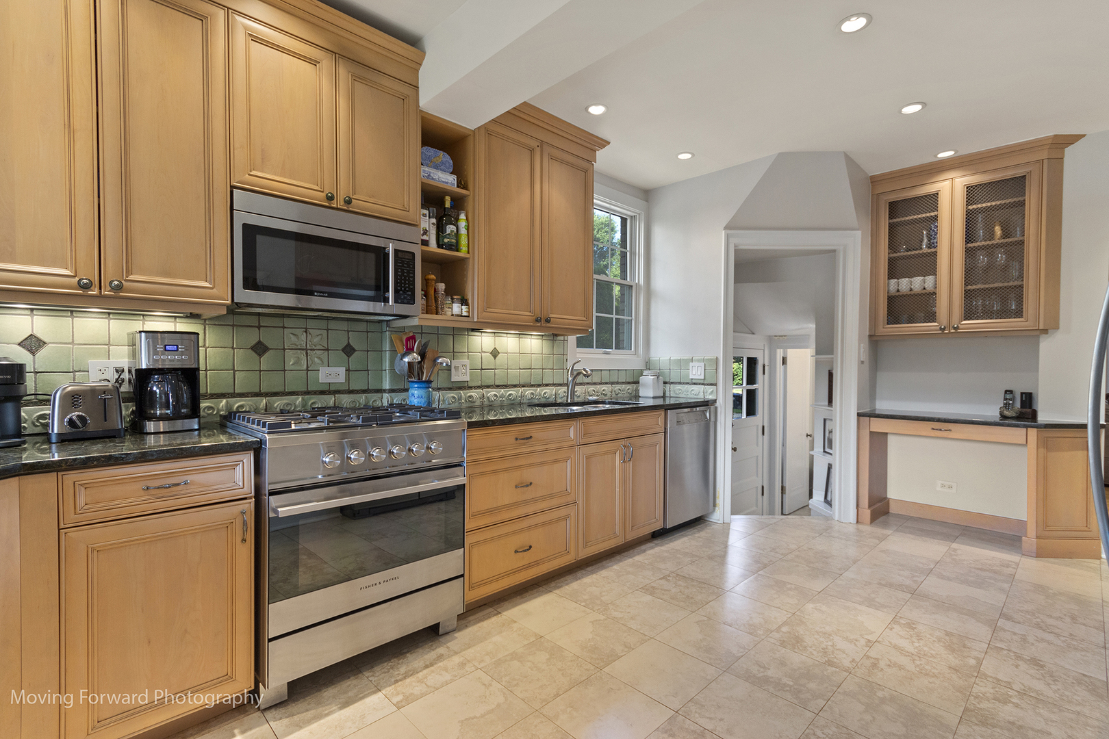 2518 Ridgeway Avenue Evanston, IL 60201 - Photo 5 of 21 a kitchen with stainless steel appliances granite countertop a stove top oven a sink dishwasher and a refrigerator with wooden cabinets
