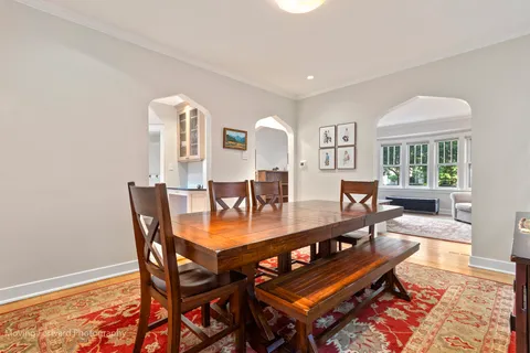 a dining room with furniture and wooden floor