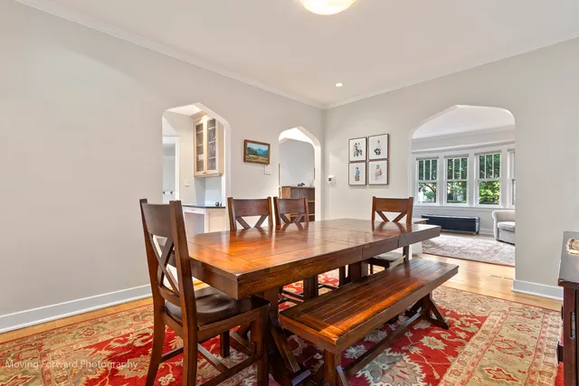 a dining room with furniture and wooden floor