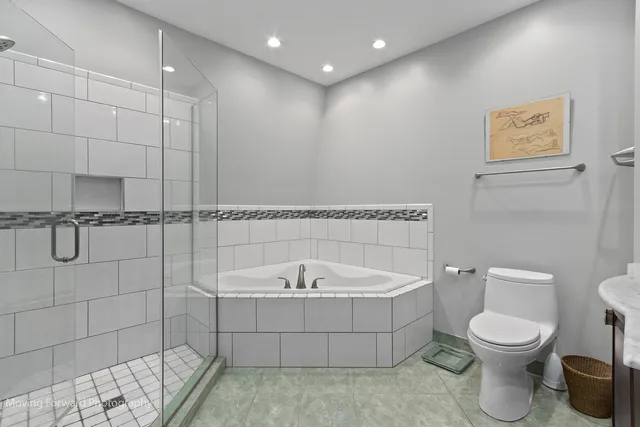 a bathroom with a toilet and a shower