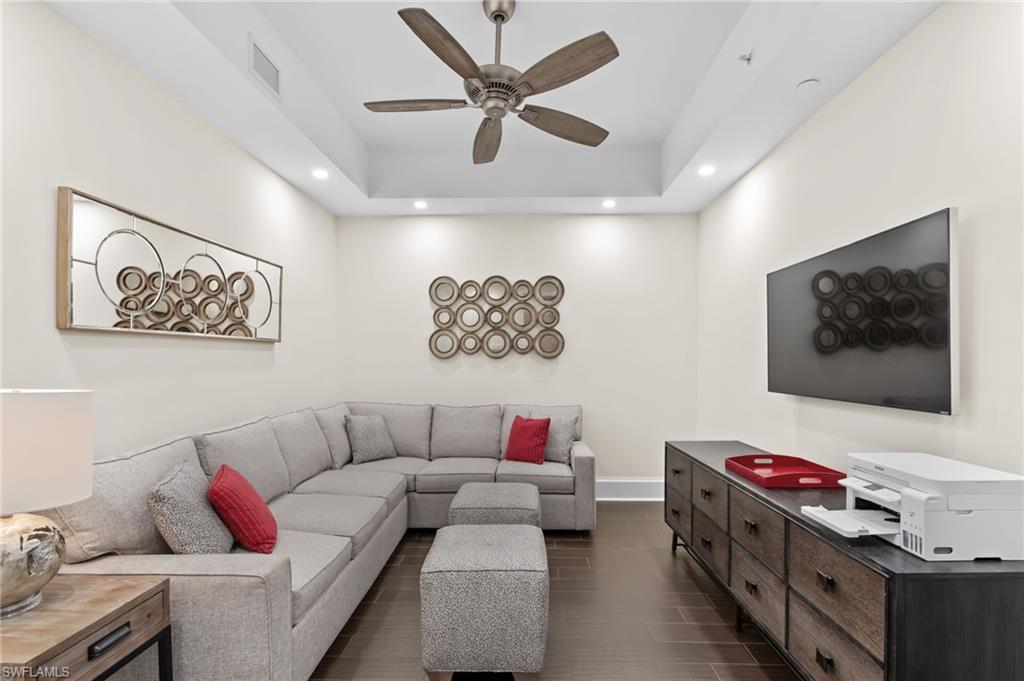 1030 3rd Avenue South, Unit 319 Naples, FL 34102 - Photo 18 of 42 a living room with furniture and a flat screen tv