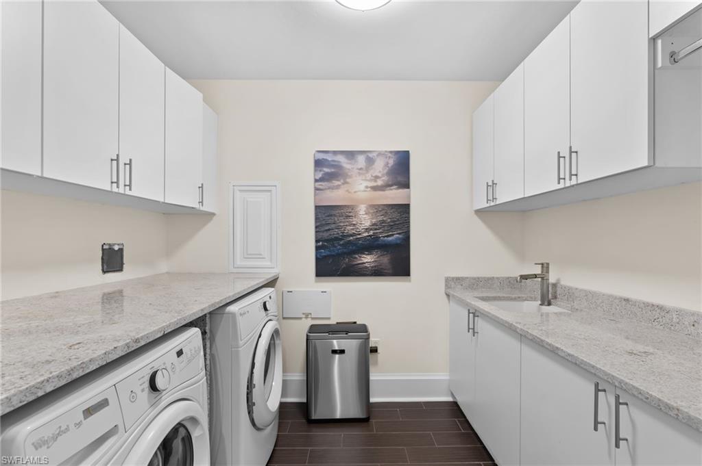 1030 3rd Avenue South, Unit 319 Naples, FL 34102 - Photo 21 of 42 a utility room with granite countertop a sink a washer and dryer