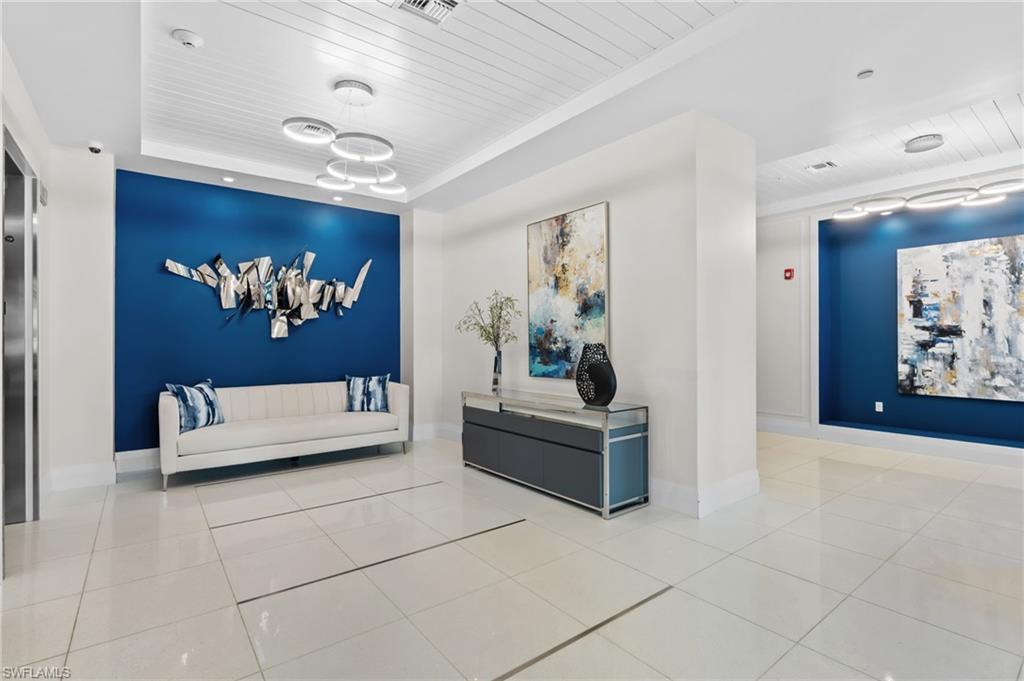 1030 3rd Avenue South, Unit 319 Naples, FL 34102 - Photo 33 of 42 a living room with furniture and a chandelier