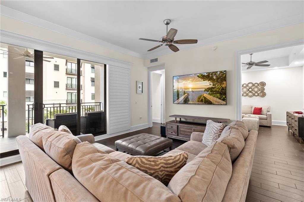 1030 3rd Avenue South, Unit 319 Naples, FL 34102 - Photo 4 of 42 a bedroom with furniture and a flat screen tv