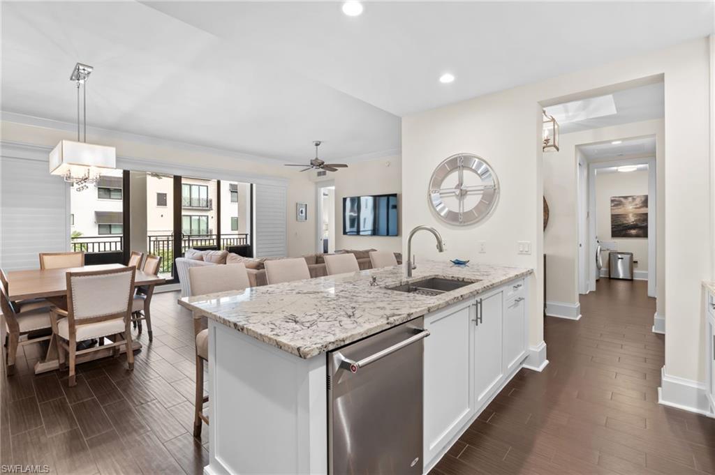 1030 3rd Avenue South, Unit 319 Naples, FL 34102 - Photo 7 of 42 a large white kitchen with a large island