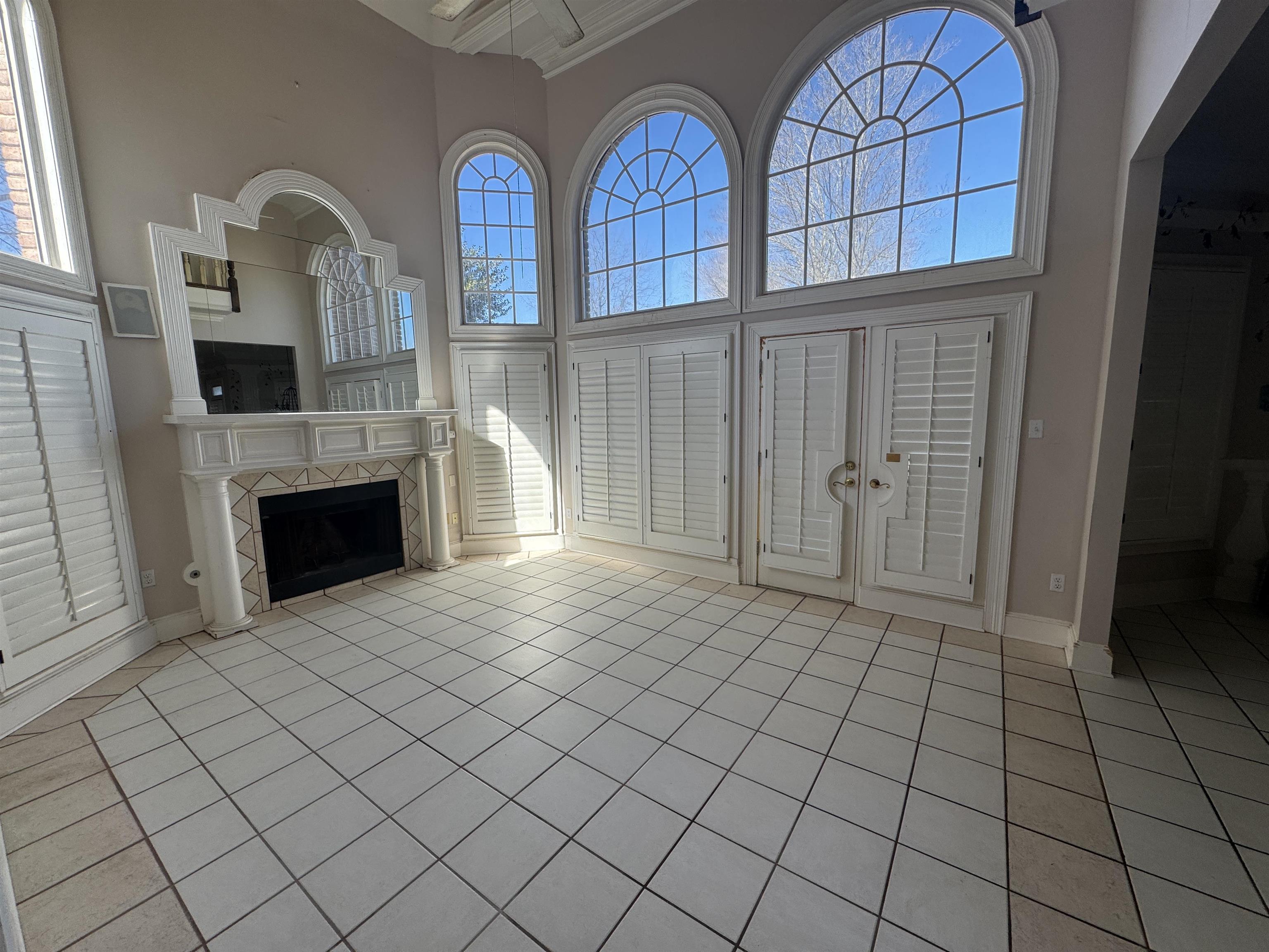 9500 Plantation Lake Road Collierville, TN 38017 - Photo 14 of 40 an empty room with windows dryer and fireplace