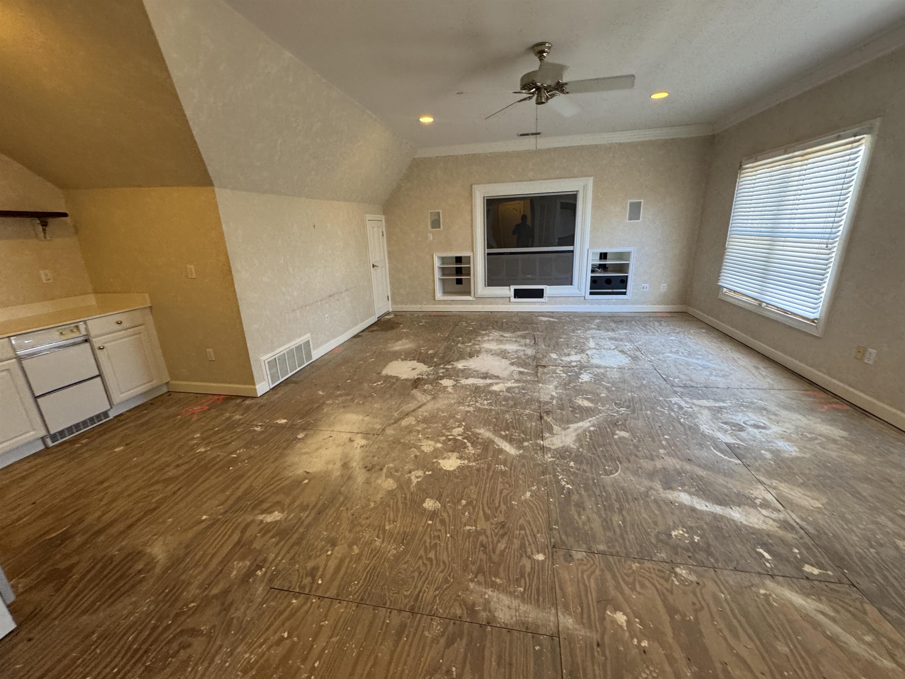 9500 Plantation Lake Road Collierville, TN 38017 - Photo 2 of 40 Unfurnished living room with crown molding, a ceiling fan, visible vents, lofted ceiling, and baseboards