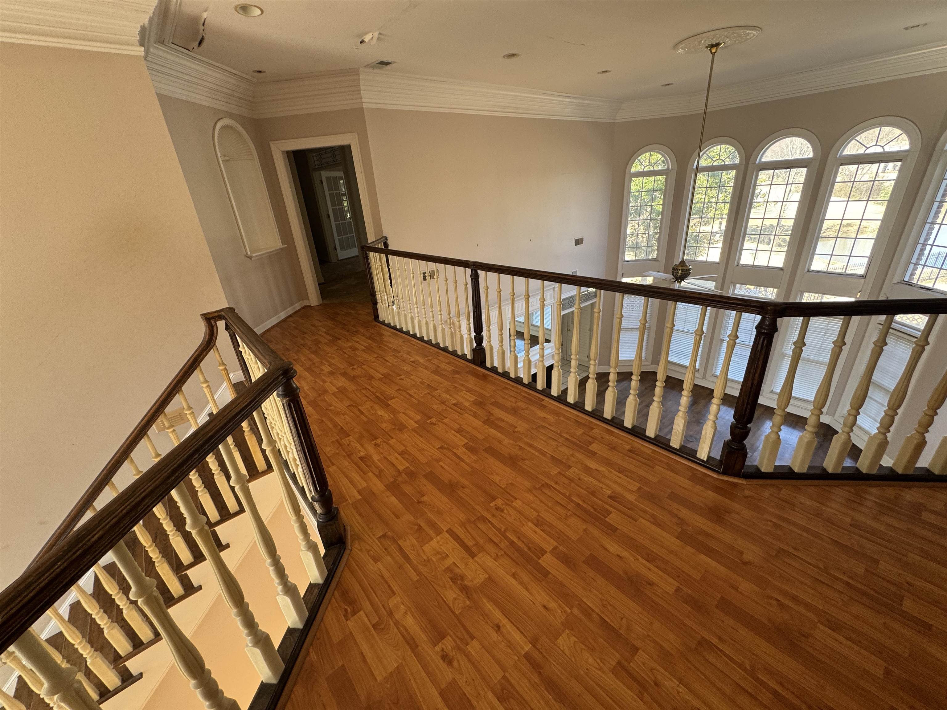 9500 Plantation Lake Road Collierville, TN 38017 - Photo 38 of 40 Hallway with ornamental molding, an upstairs landing, and wood finished floors