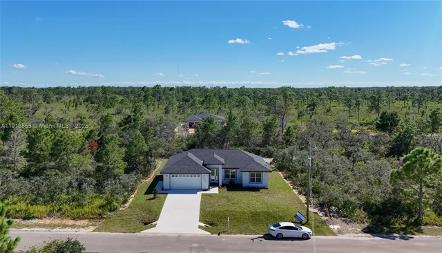 a aerial view of a house with a yard