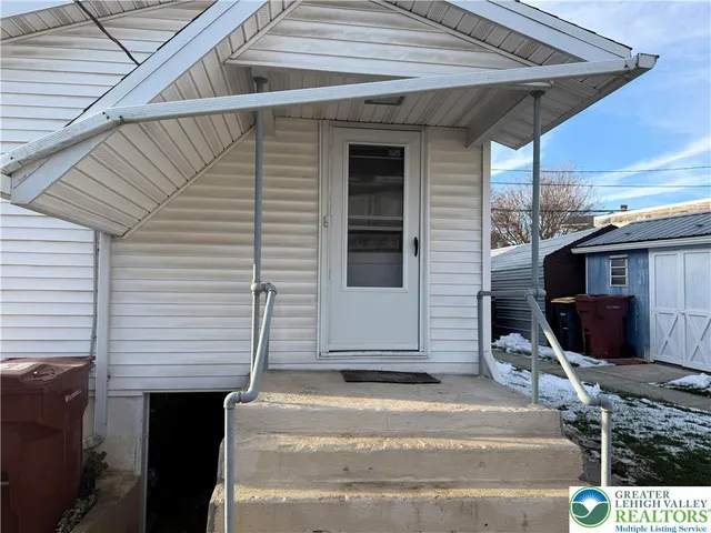 a front view of a house with stairs