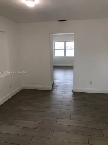 a view of wooden floor and windows in a room