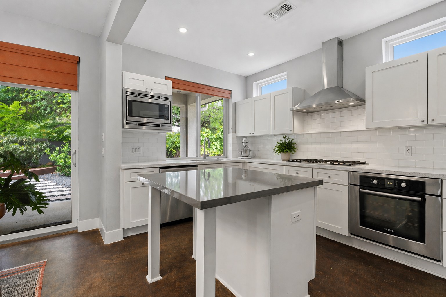 1303 Azie Morton Road, Unit 2 Austin, TX 78704 - Photo 11 of 36 a kitchen with stainless steel appliances granite countertop a stove a sink and a microwave