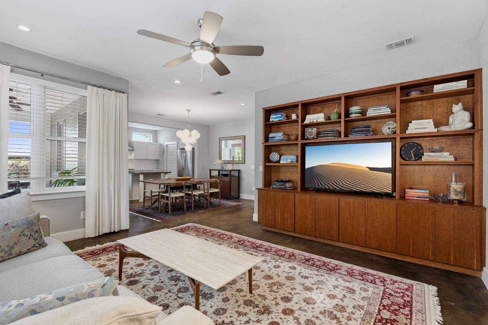 1303 Azie Morton Road, Unit 2 Austin, TX 78704 - Photo 16 of 37 Custom built-in cabinetry and shelving provide integrated storage and display space, centered around a media area.