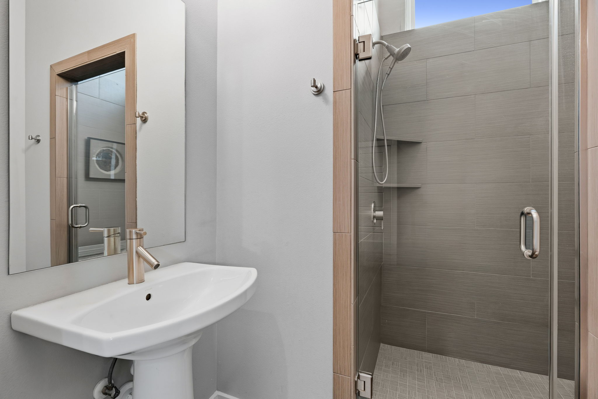 1303 Azie Morton Road, Unit 2 Austin, TX 78704 - Photo 18 of 37 Downstairs bathroom includes a walk-in glass shower with tile surround and built-in niche.