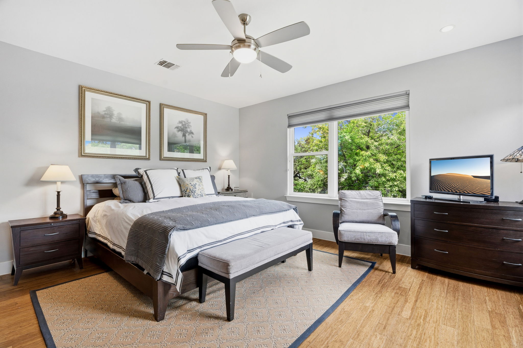 1303 Azie Morton Road, Unit 2 Austin, TX 78704 - Photo 19 of 37 Spacious primary bedroom with large window views of surrounding greenery and ample natural light.