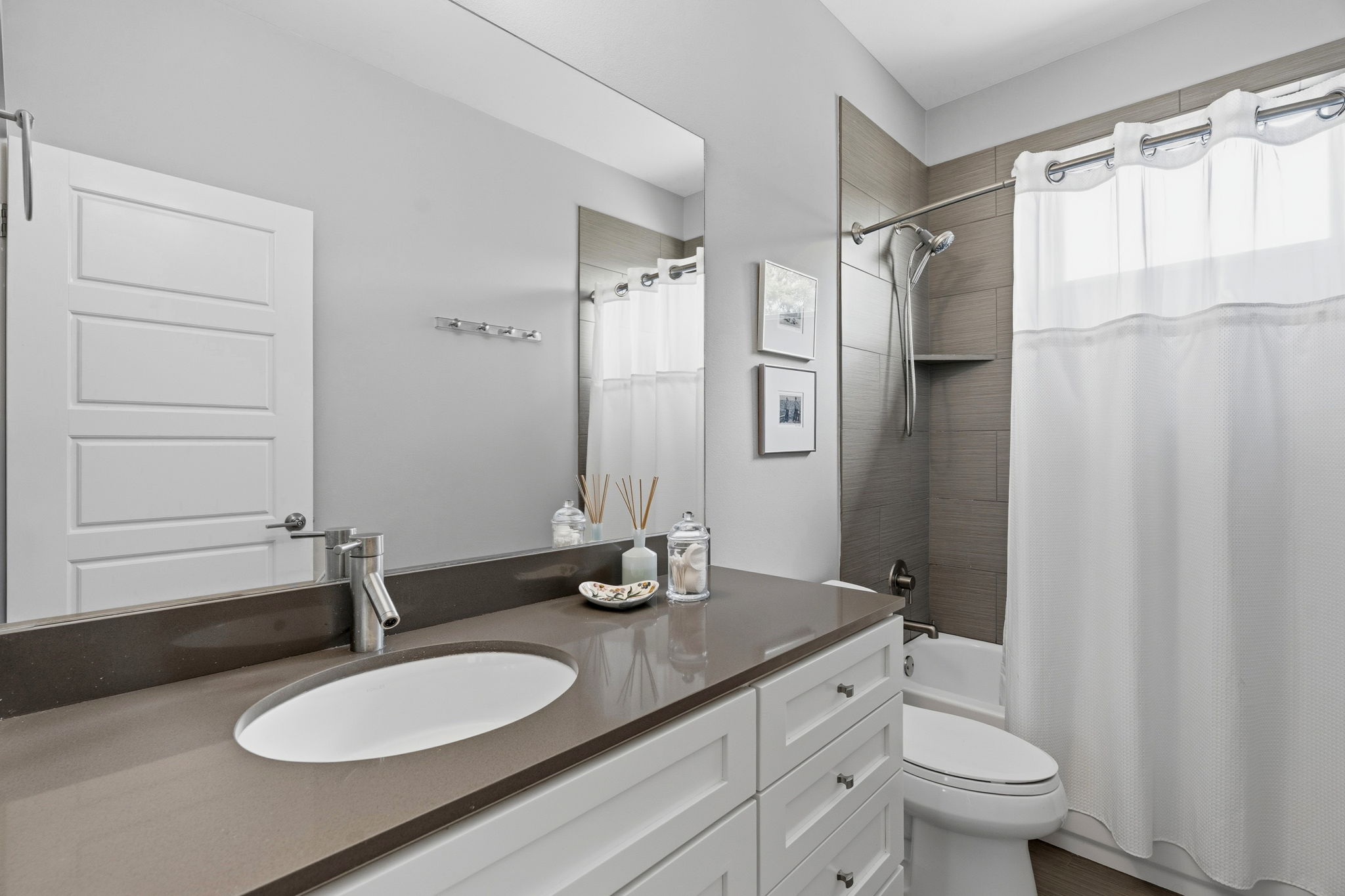 1303 Azie Morton Road, Unit 2 Austin, TX 78704 - Photo 24 of 36 a bathroom with a granite countertop sink toilet a mirror a shower and a mirror