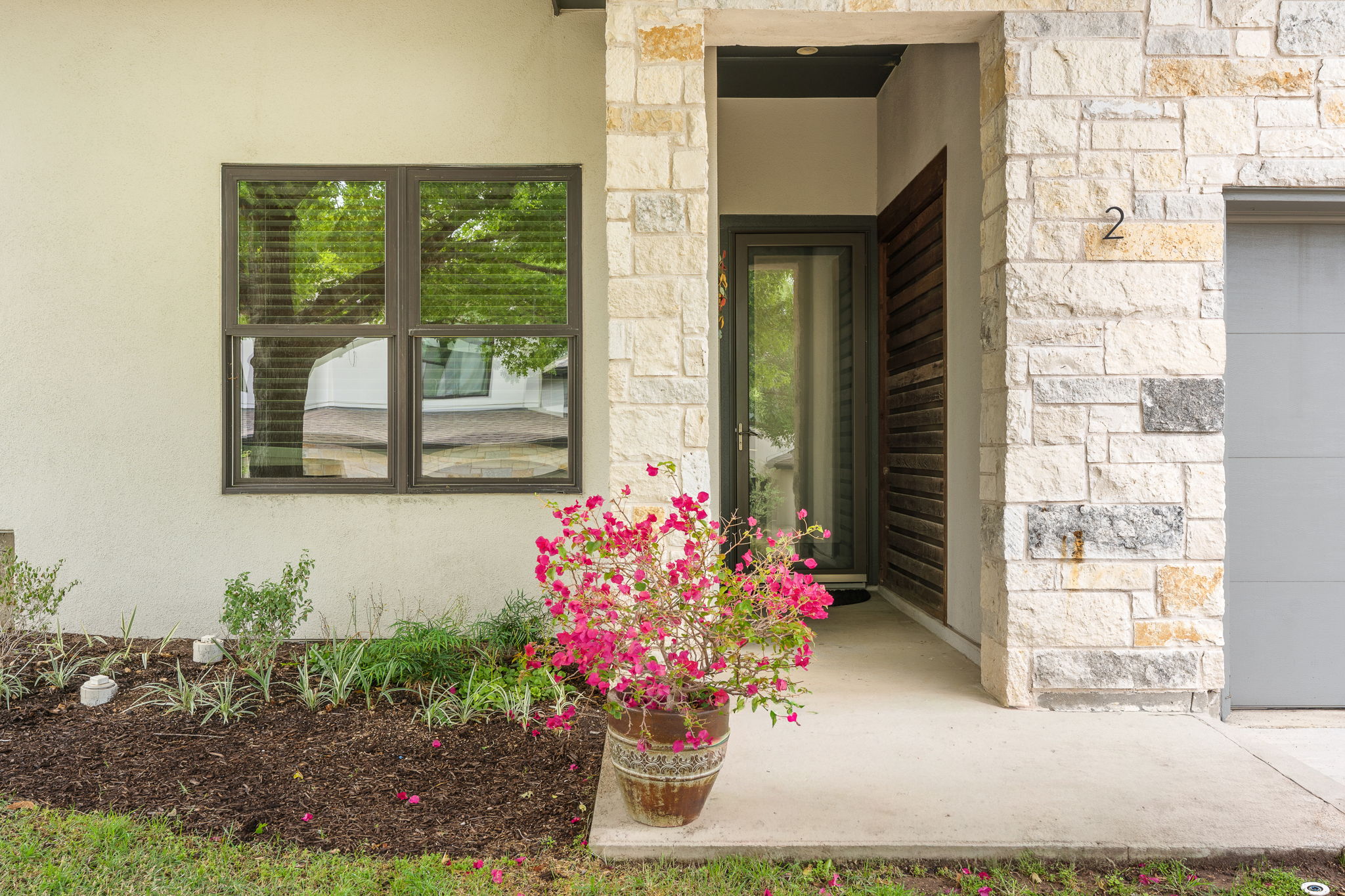 1303 Azie Morton Road, Unit 2 Austin, TX 78704 - Photo 34 of 36 a flowers in front of a house
