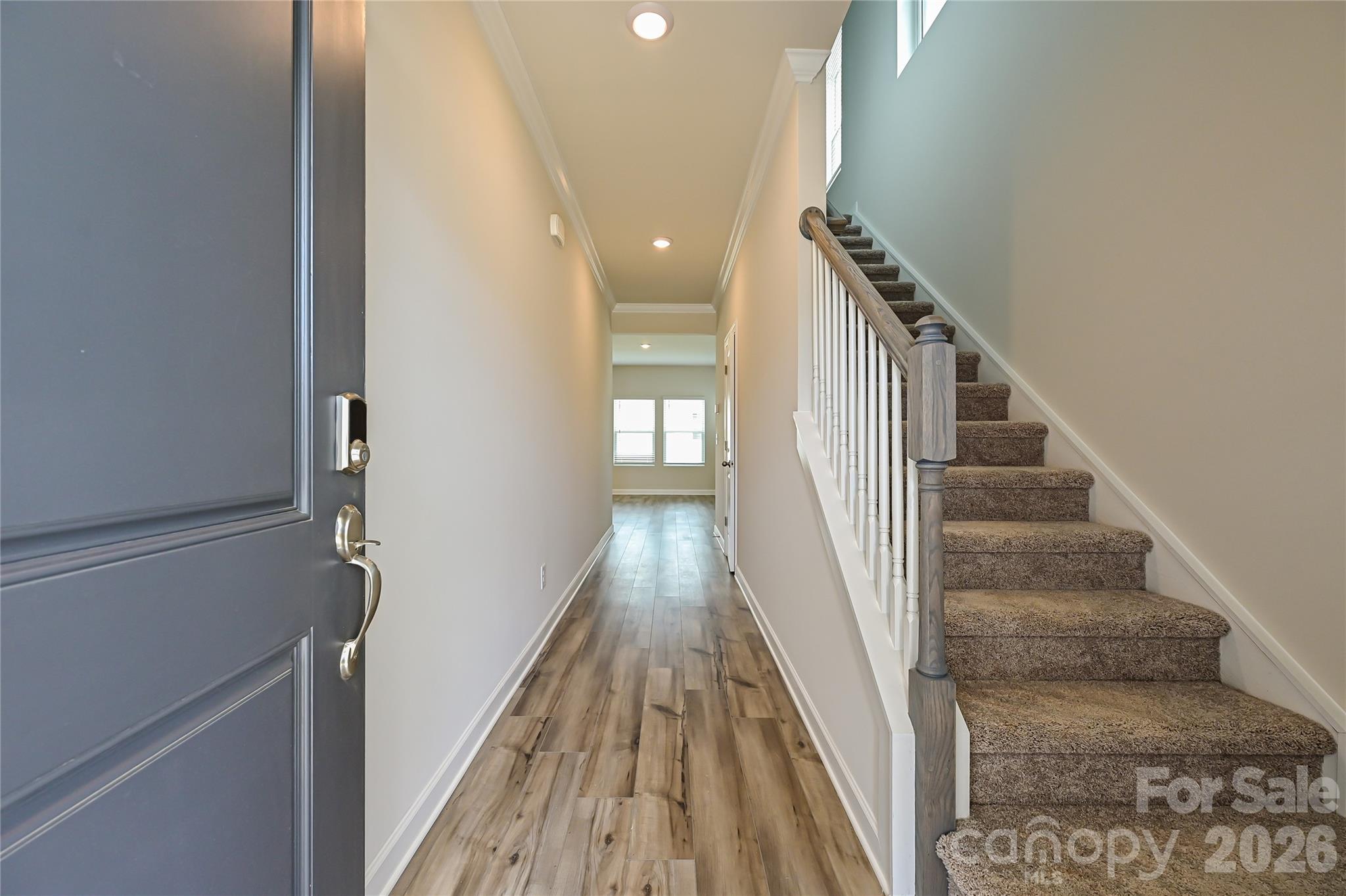 1308 30th St Lane Northeast Conover, NC 28613 - Photo 2 of 12 a view of a hallway with wooden floor and staircase