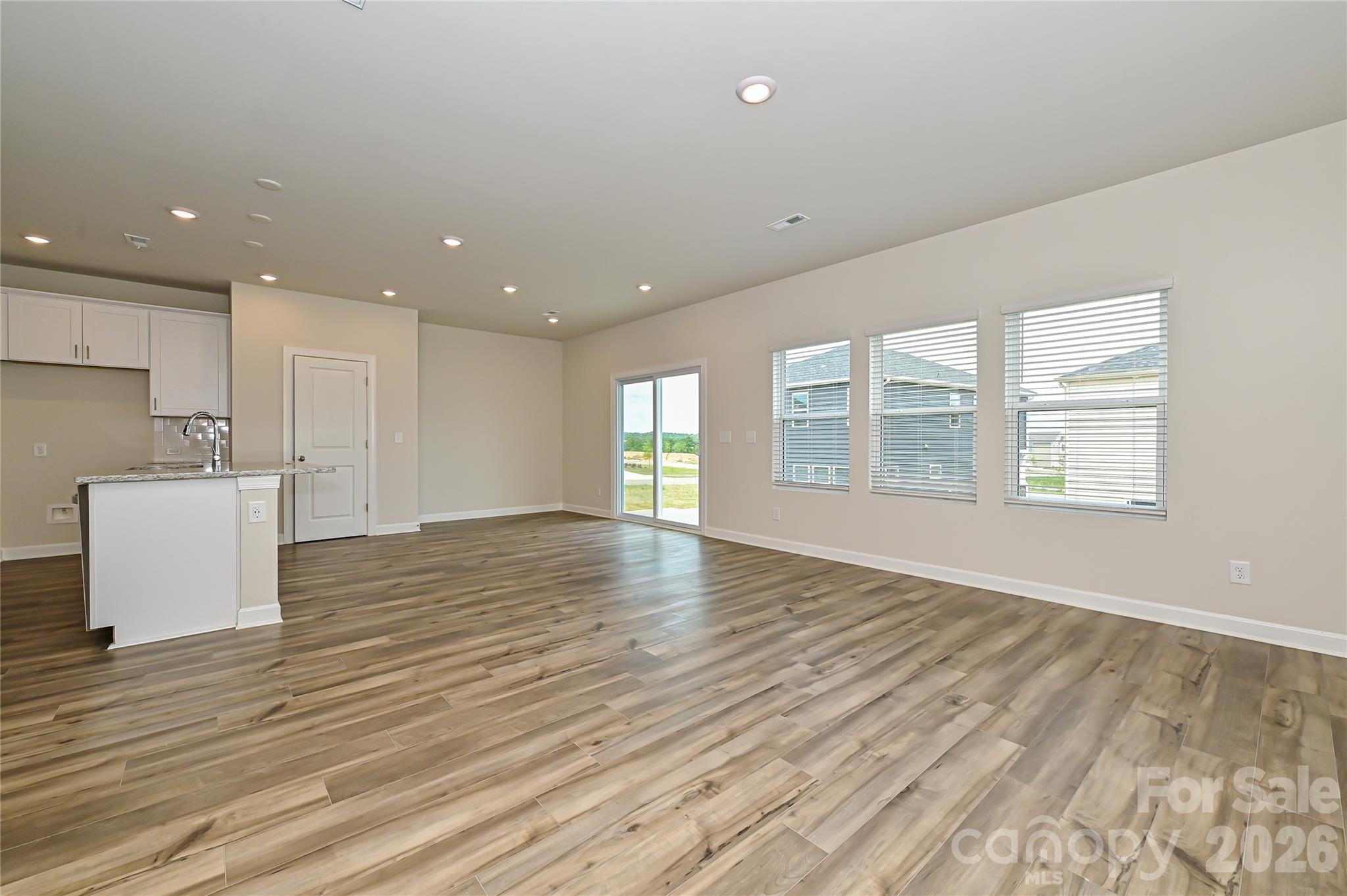 1308 30th St Lane Northeast Conover, NC 28613 - Photo 3 of 12 an empty room with wooden floor and windows