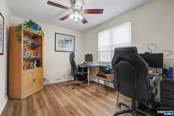 a view of a workspace with furniture and a window