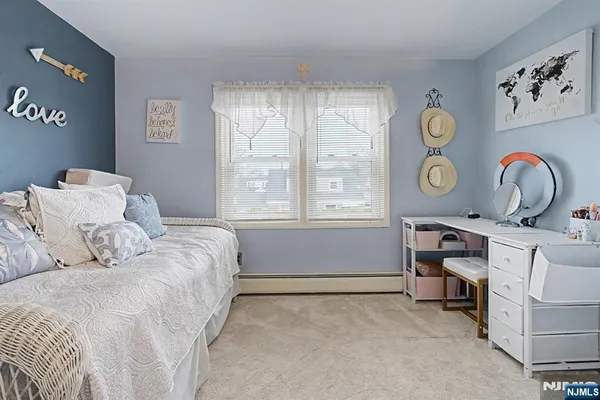 a bed room with a bed and a chair