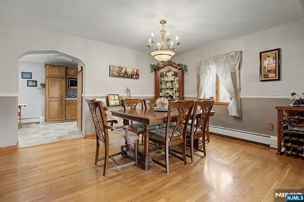 a view of a dining room with furniture wooden floor and chandelier