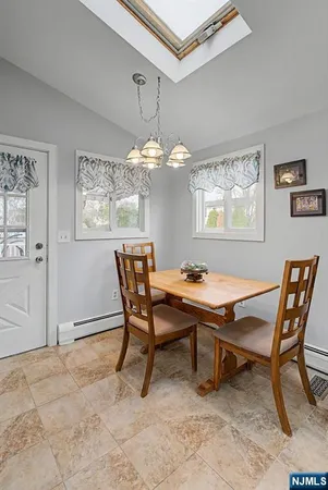 a dining room with a wooden table and chairs