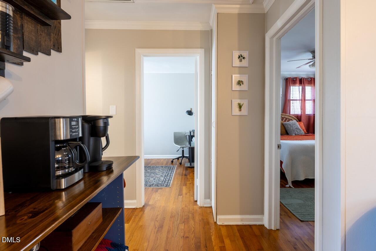 2333 Bernard Street Raleigh, NC 27608 - Photo 4 of 19 a view of a hallway to a livingroom and a dining room with furniture
